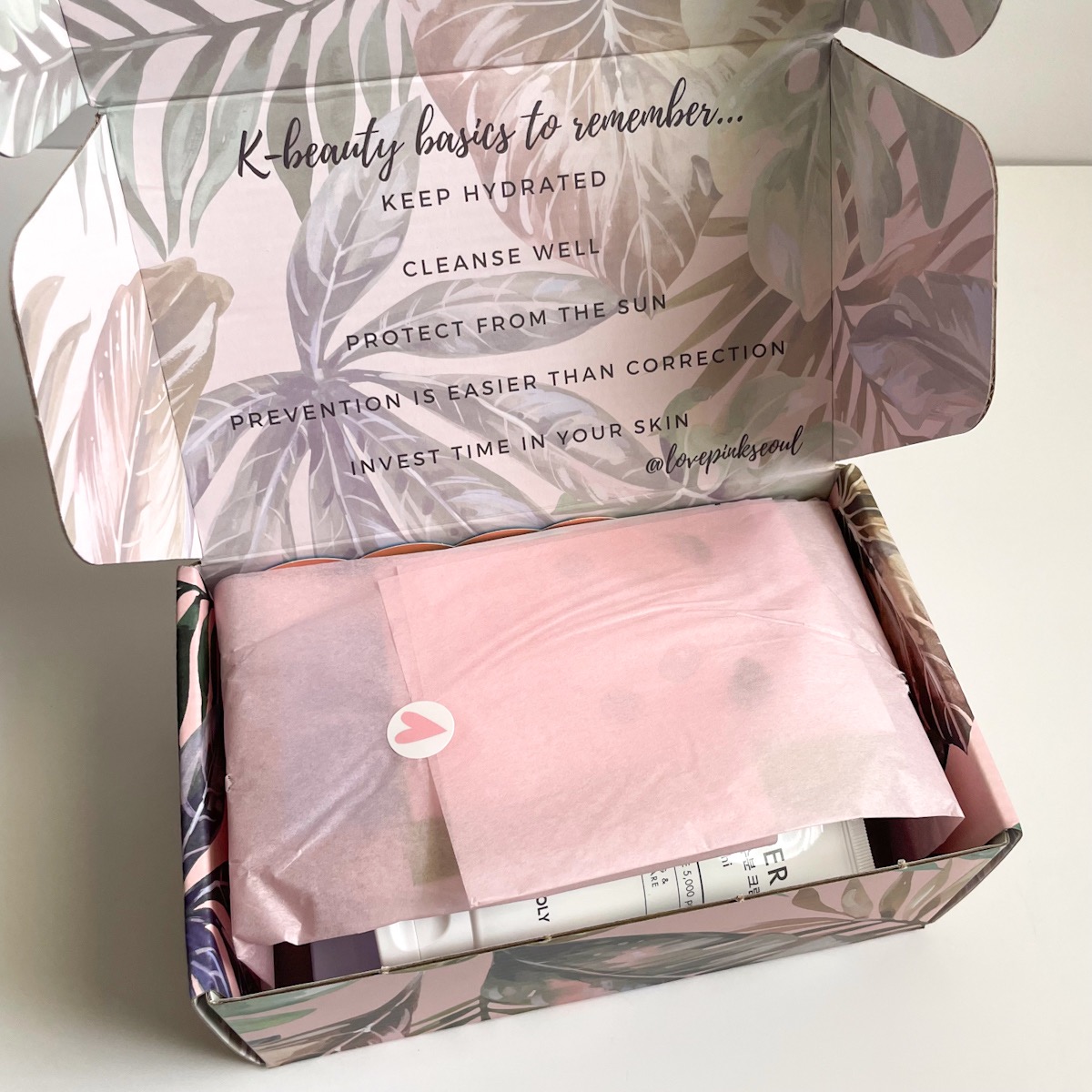 opened pink box showing pink tissue paper