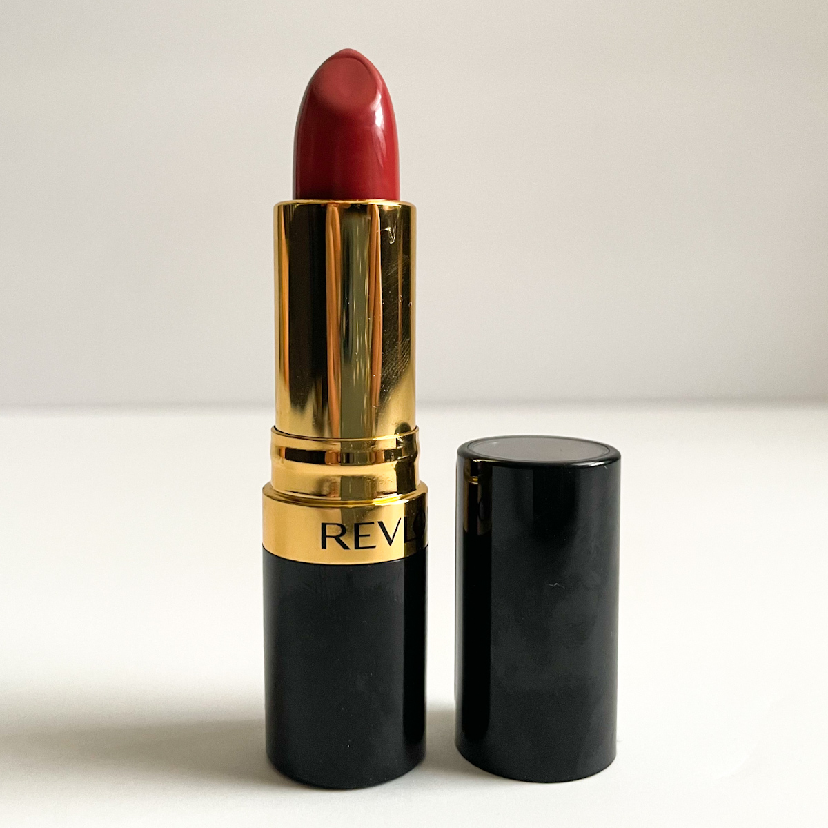 opened lipstick showing rose color and gold accents