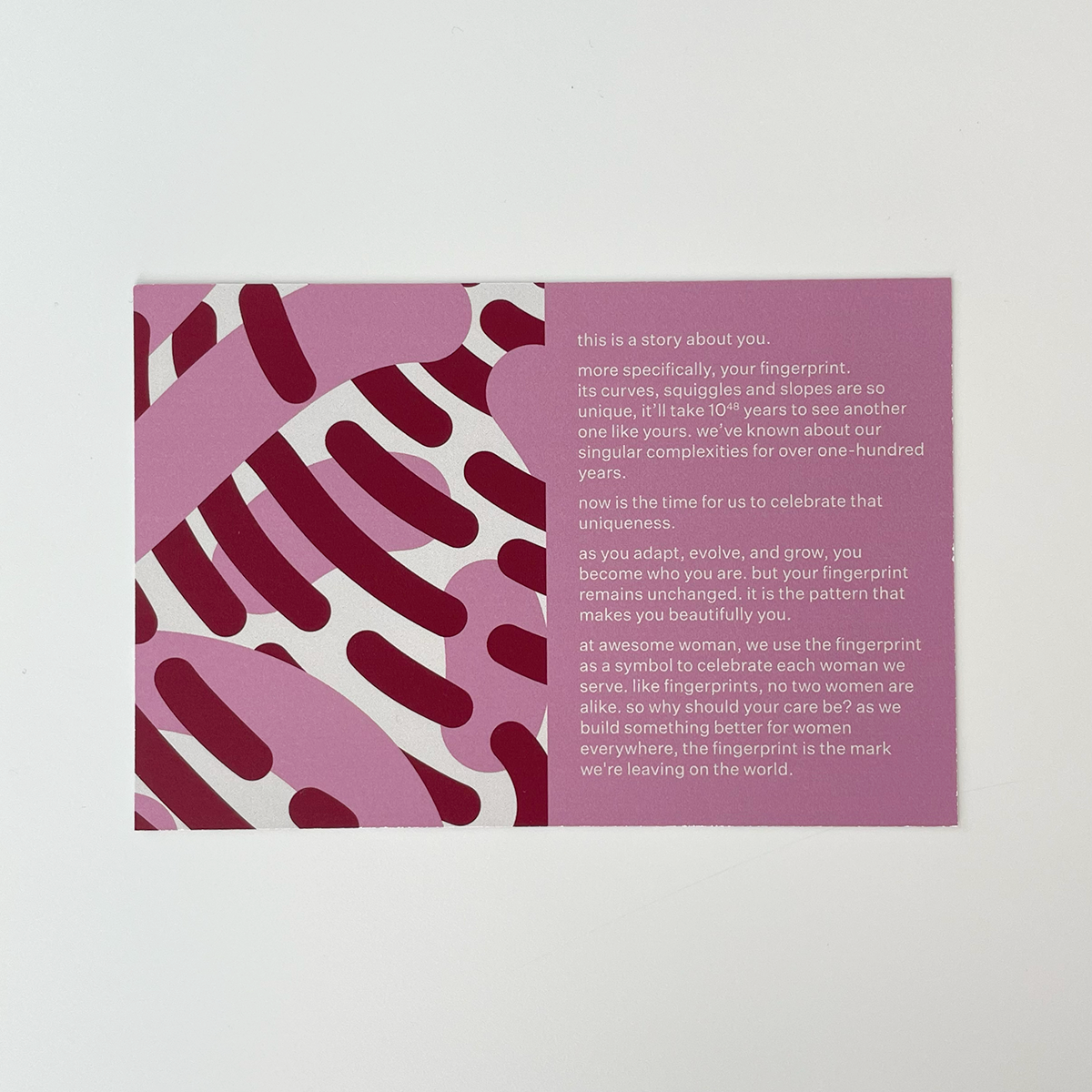 white, maroon, and pink information card about Awesome Woman