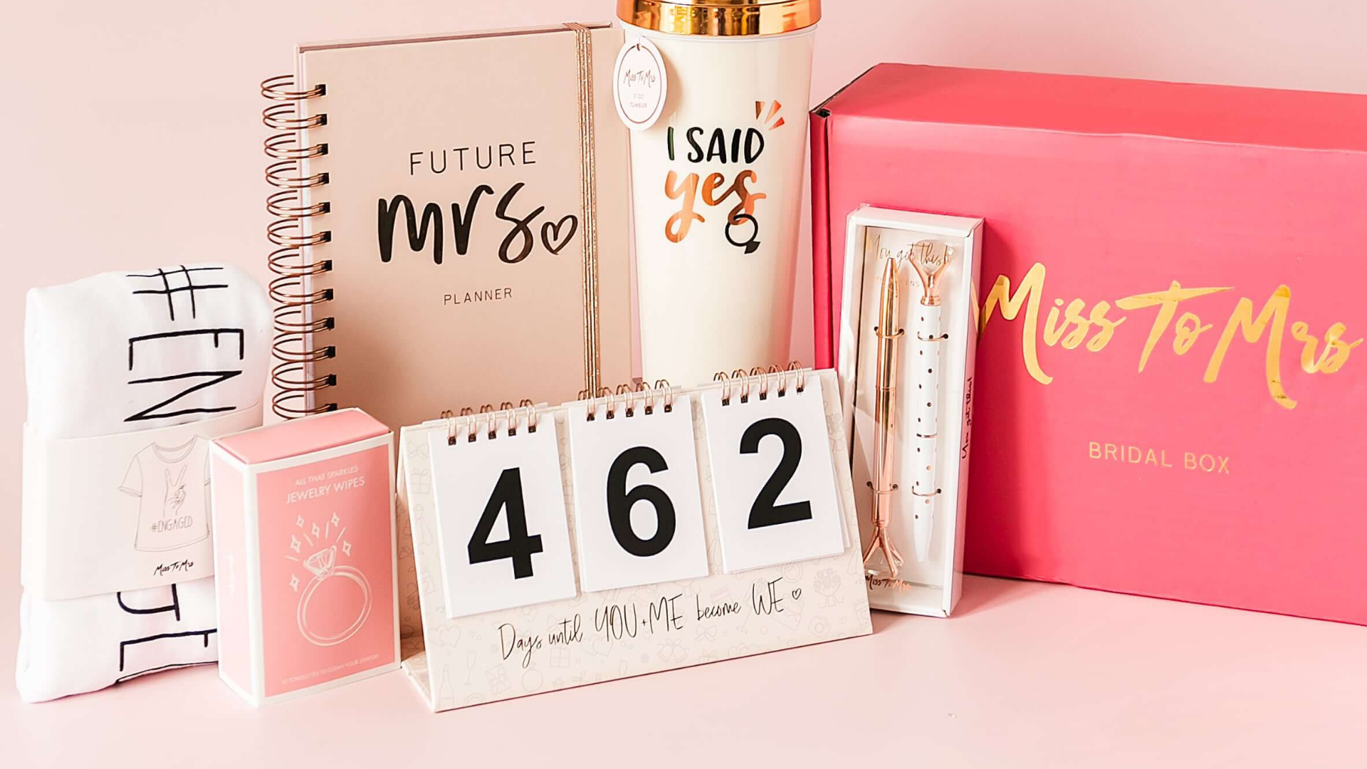 Bride-to-be gifts against a pink background