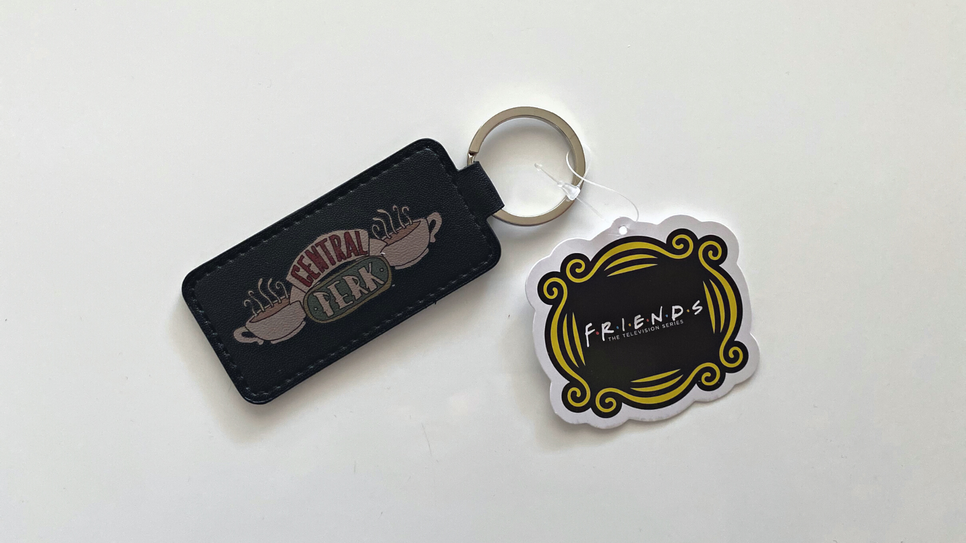 magnet keychain with central perk logo and friends logo