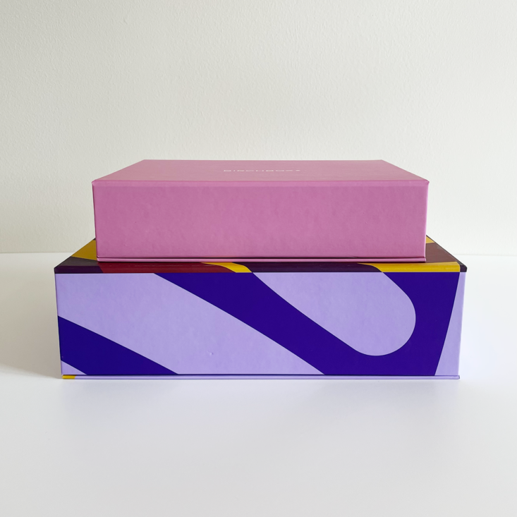 Pink Birchbox sitting on top of purple and lilac Birchbox for comparison