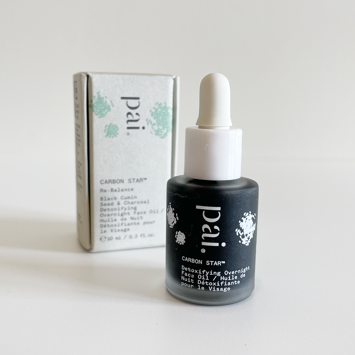 full size Pai Carbon Star facial oil with packaging in the background