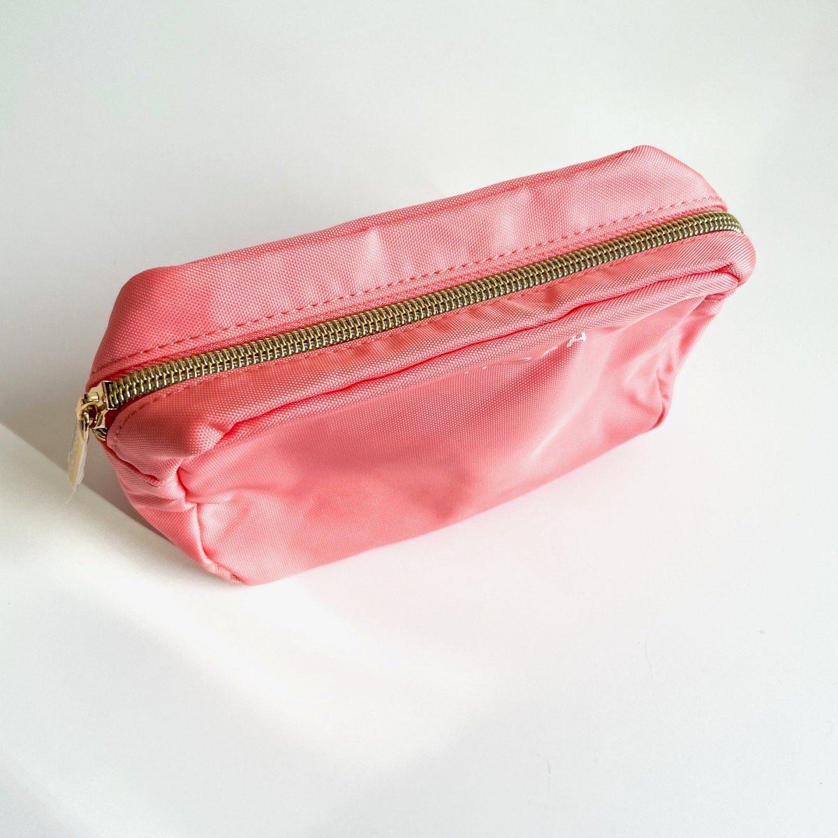 pink makeup bag on white background, alternate view