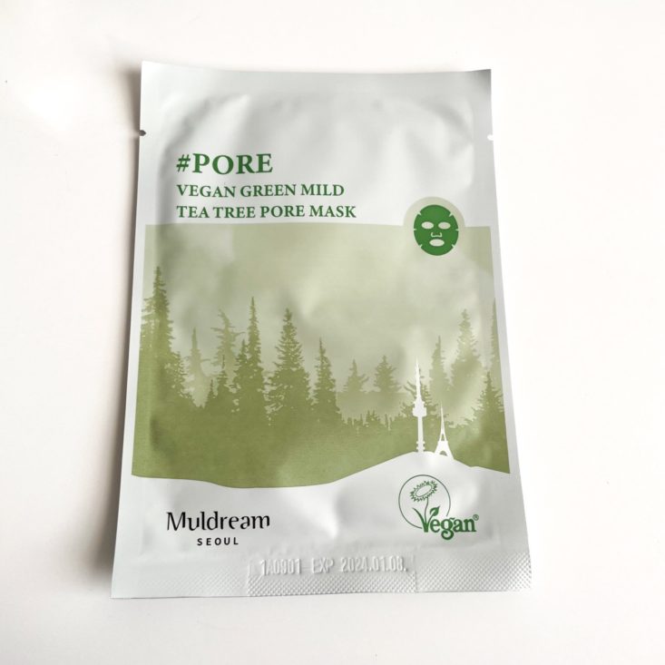 green and white sheet mask showing a forest 