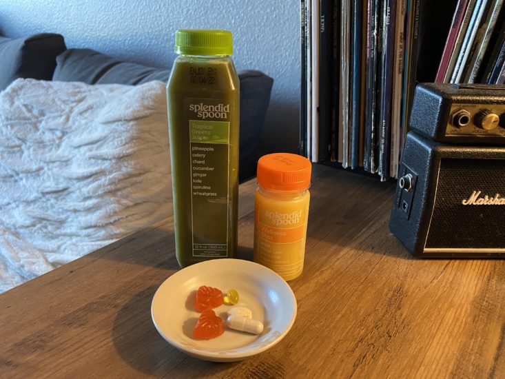Splendid Spoon green juice and wellness shot near plate of vitamins