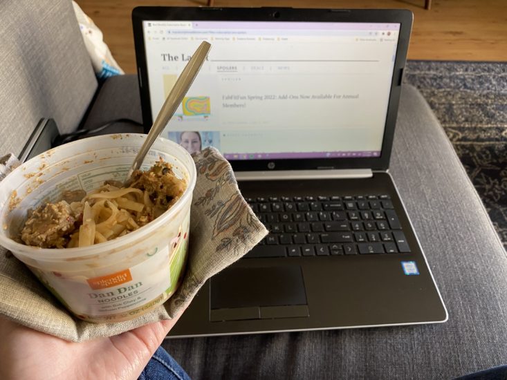 Bowl of Dan Dan noodles from Splendid Spoon near laptop