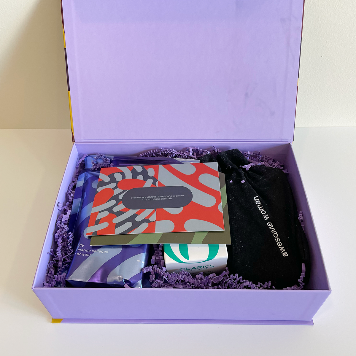 Lilac box with the lid lifted to reveal inside contents