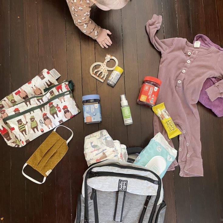 Baby with diaper bag and all its contents