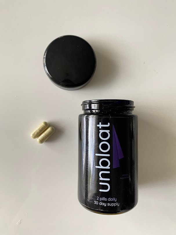 opened unbloat bottle with pills on a table