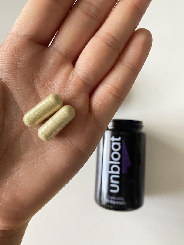 unbloat pills on a hand