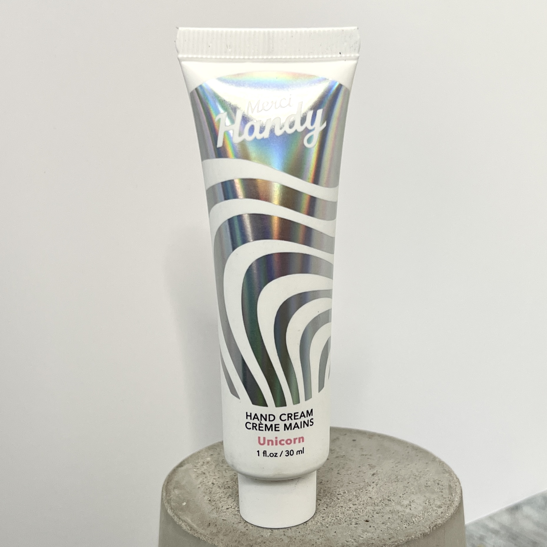 Front of Merci Handy Hand Cream in Unicorn for Glossybox March 2022