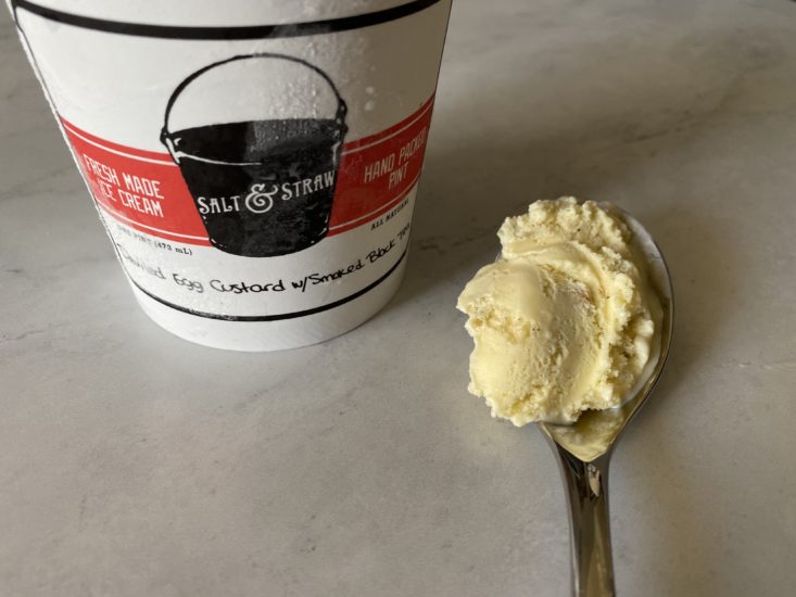 deviled egg custard and smoked black tea ice cream on spoon