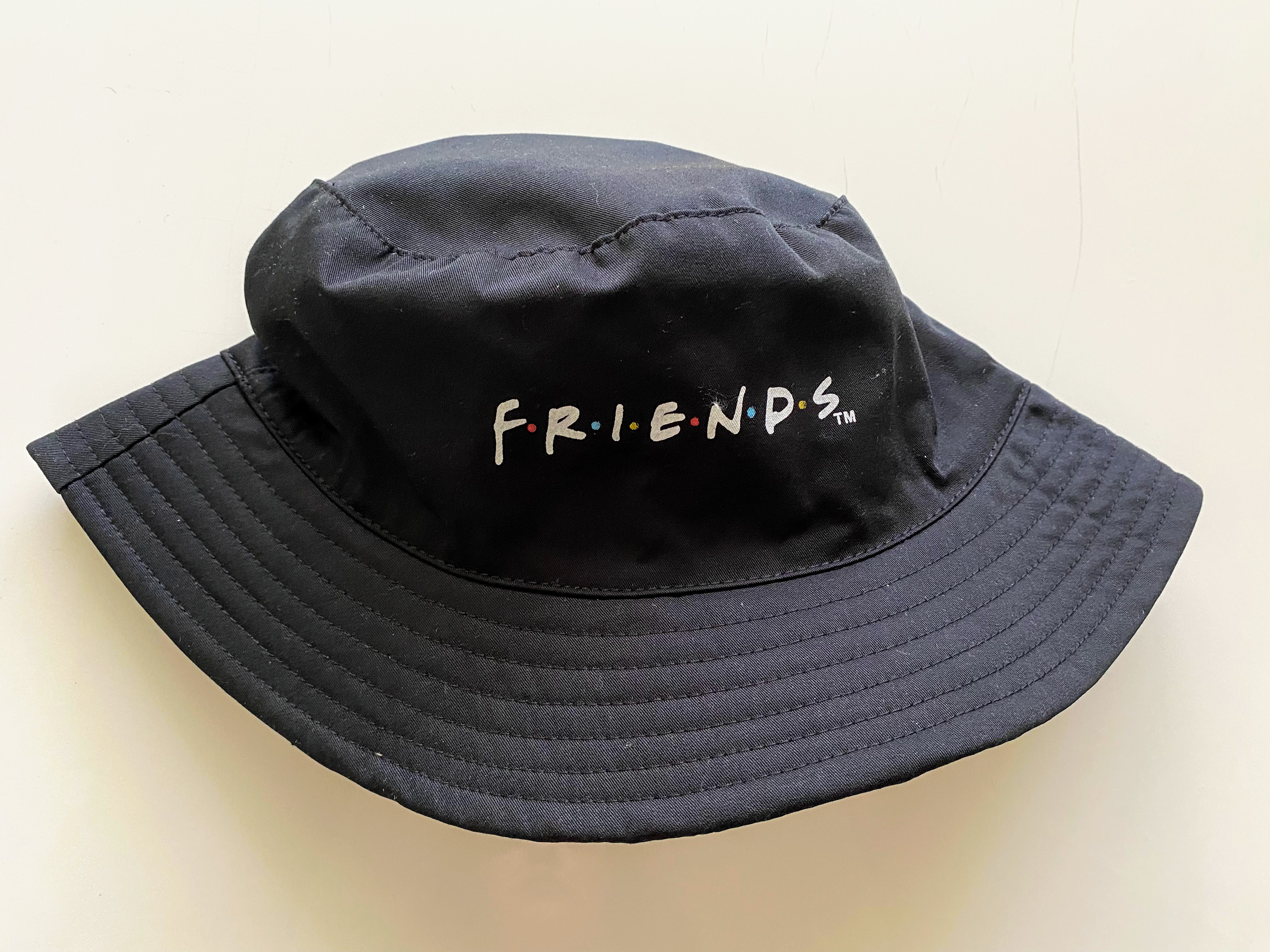 black bucket hat with the friends logo