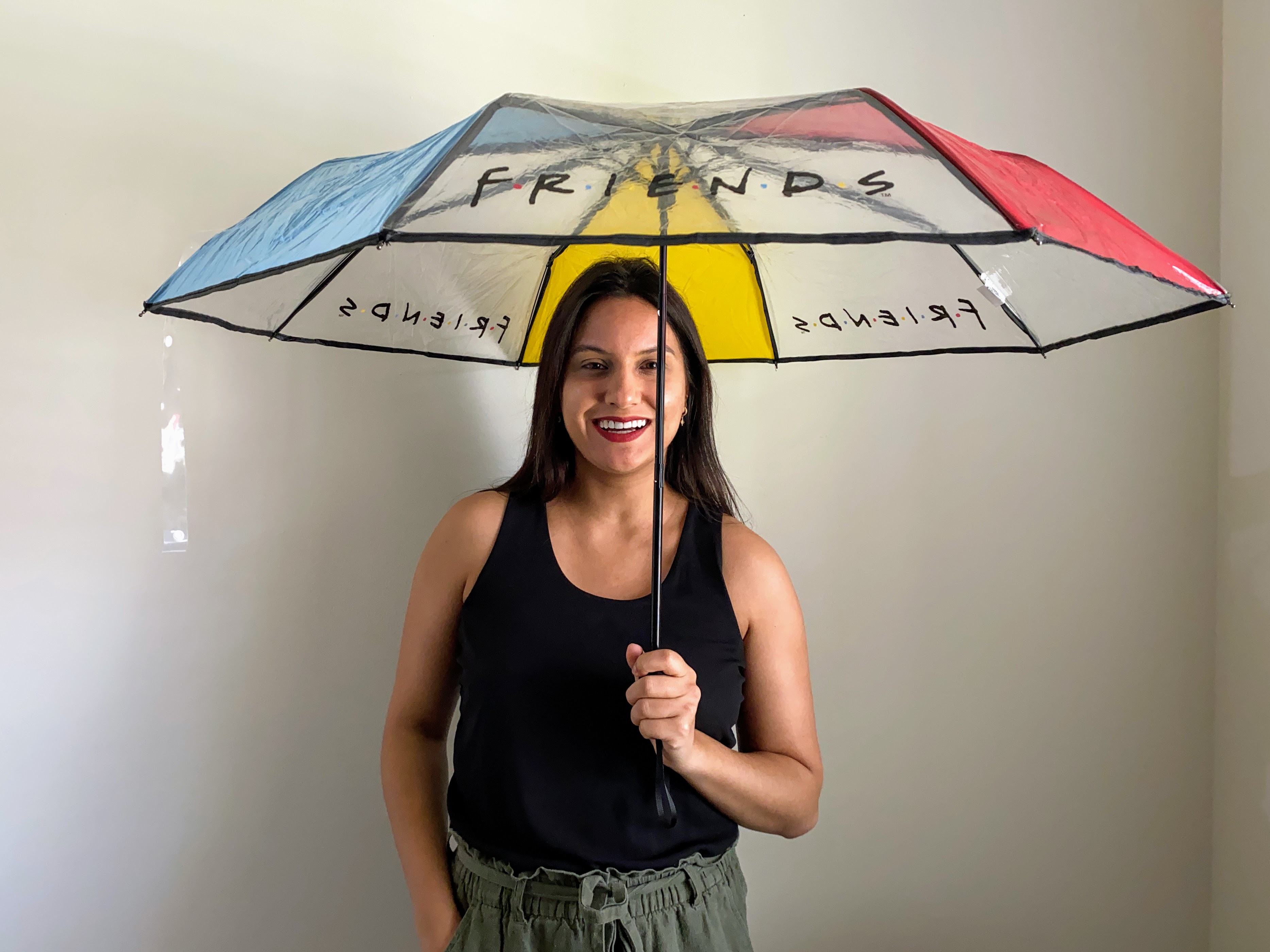 woman holding an umbrella with the friends logo