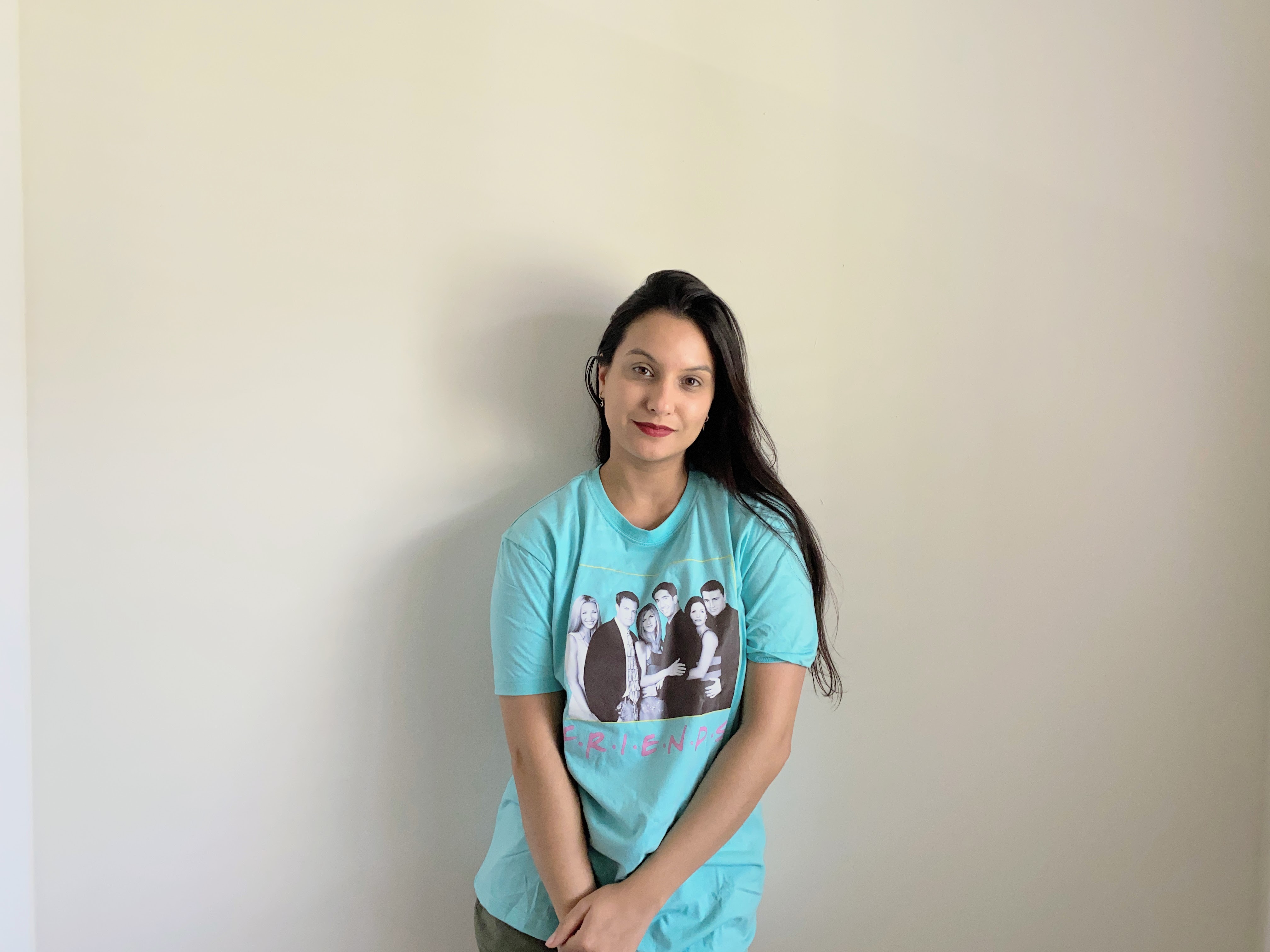 woman wearing a blue tshirt with friends logo and photo