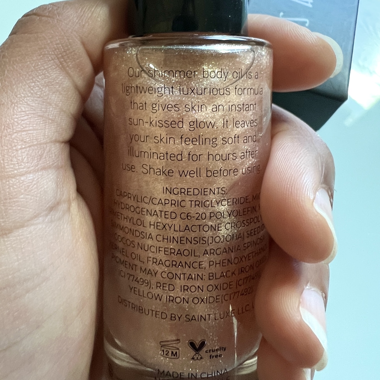 Back of Saint Luxe Shimmer Body Oil for Cocotique Makeup Lovers Box Spring 2022