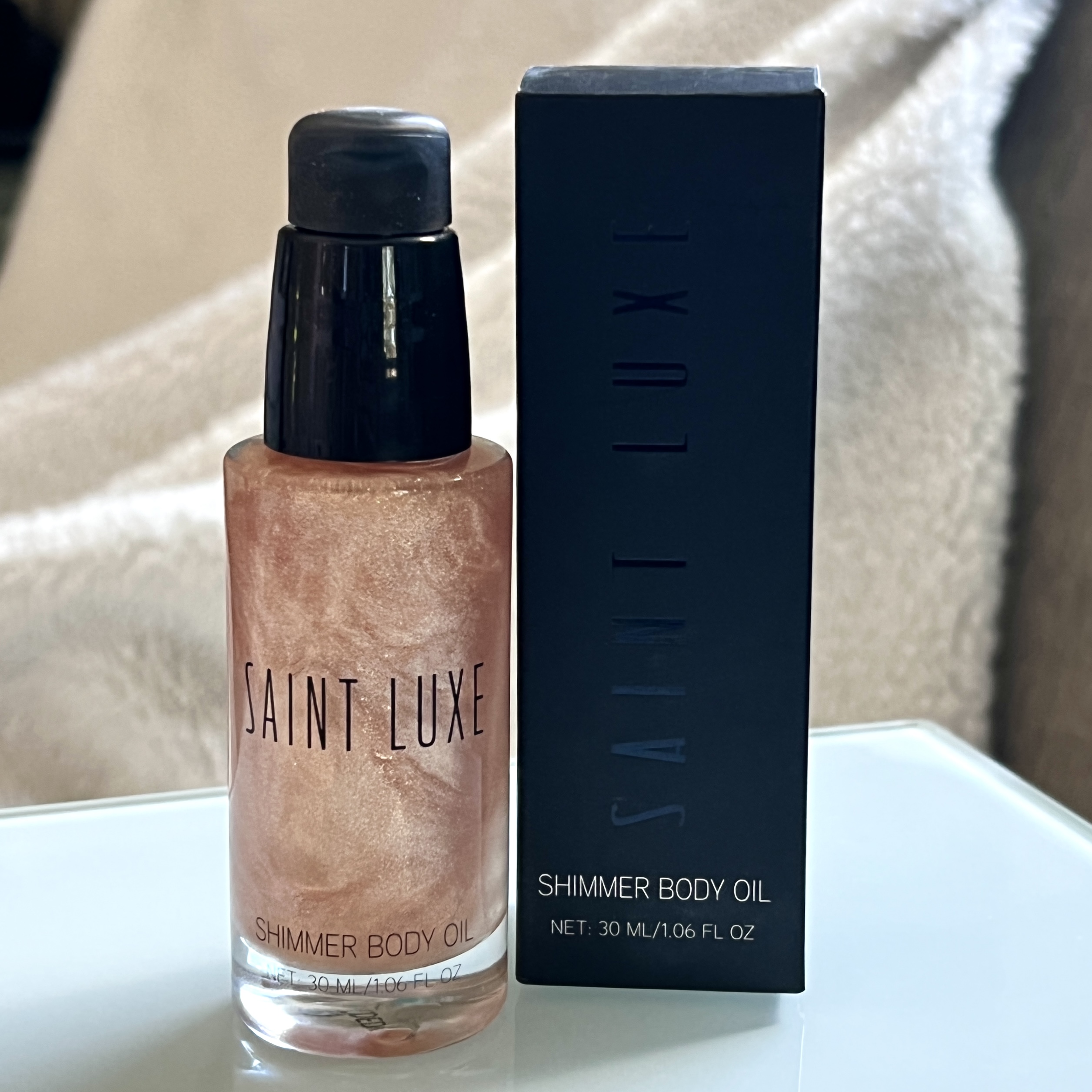 Front of Saint Luxe Shimmer Body Oil for Cocotique Makeup Lovers Box Spring 2022