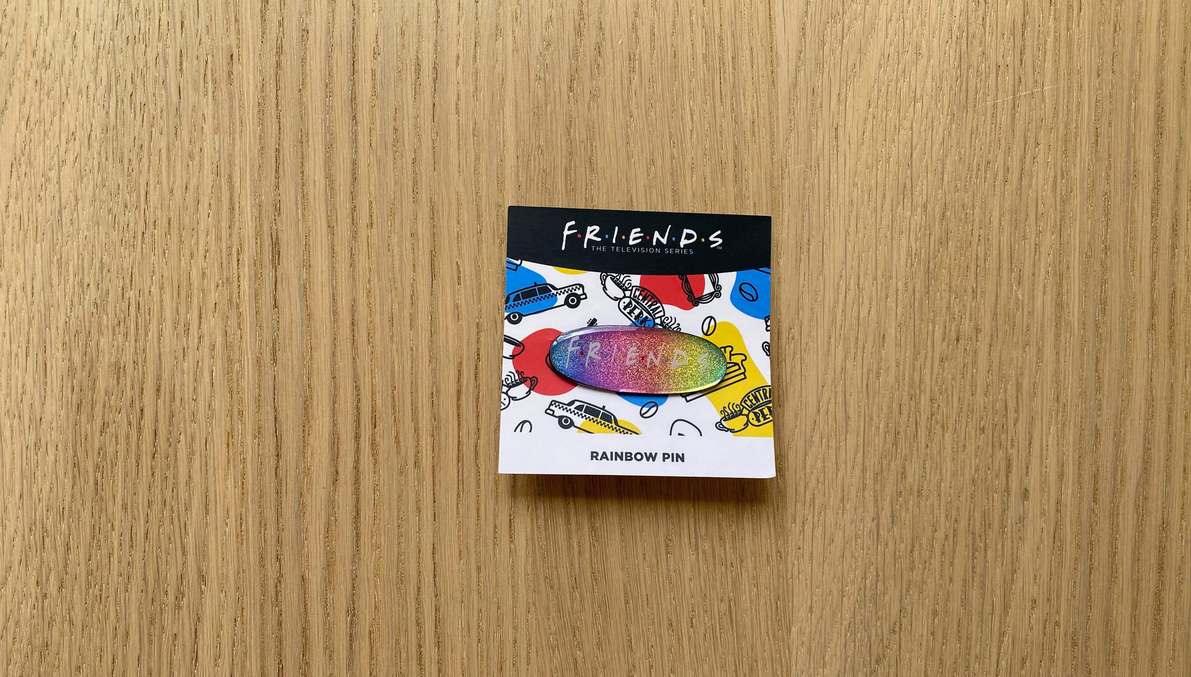 rainbow pin with the friends logo