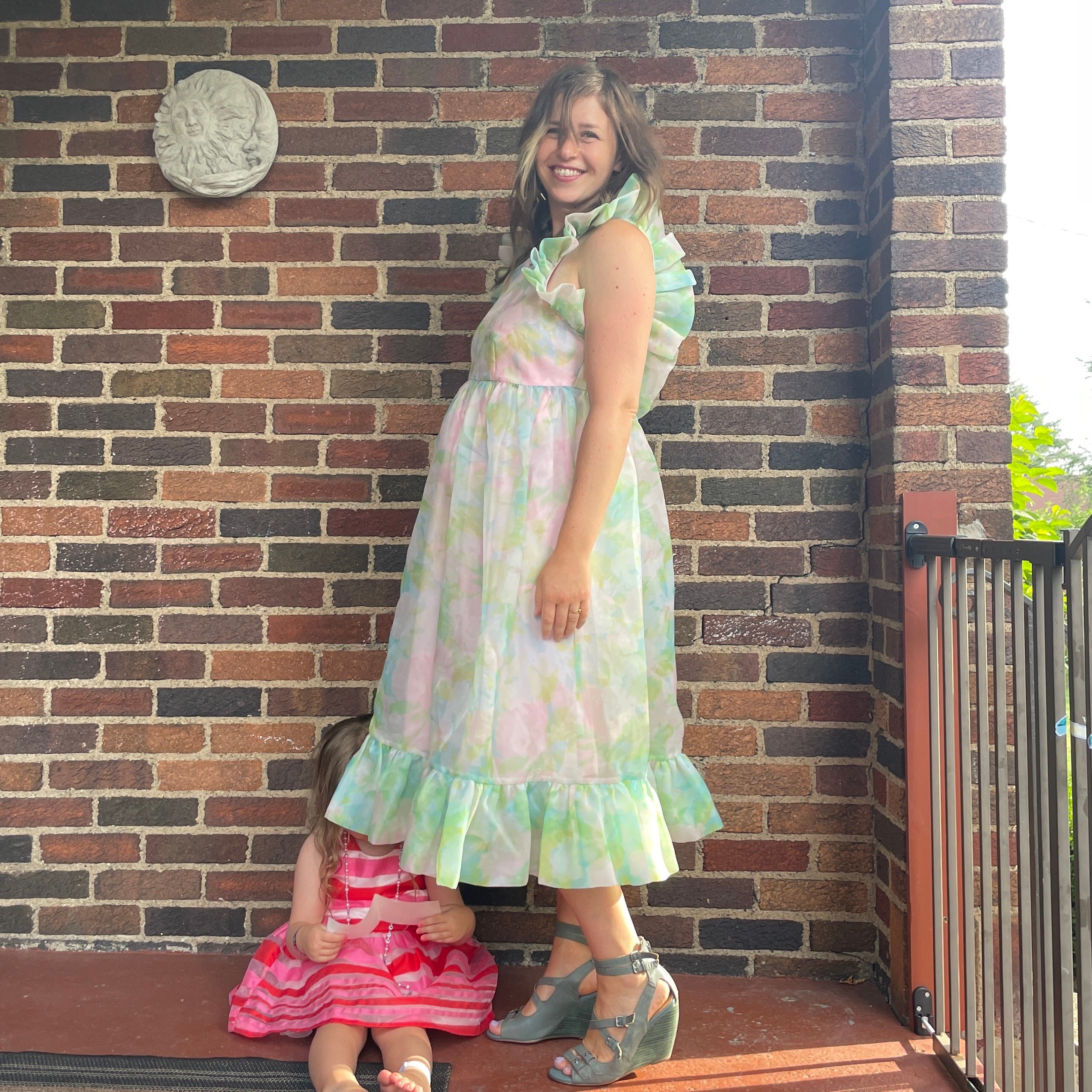 reviewer wearing frilly pastel nuuly dress