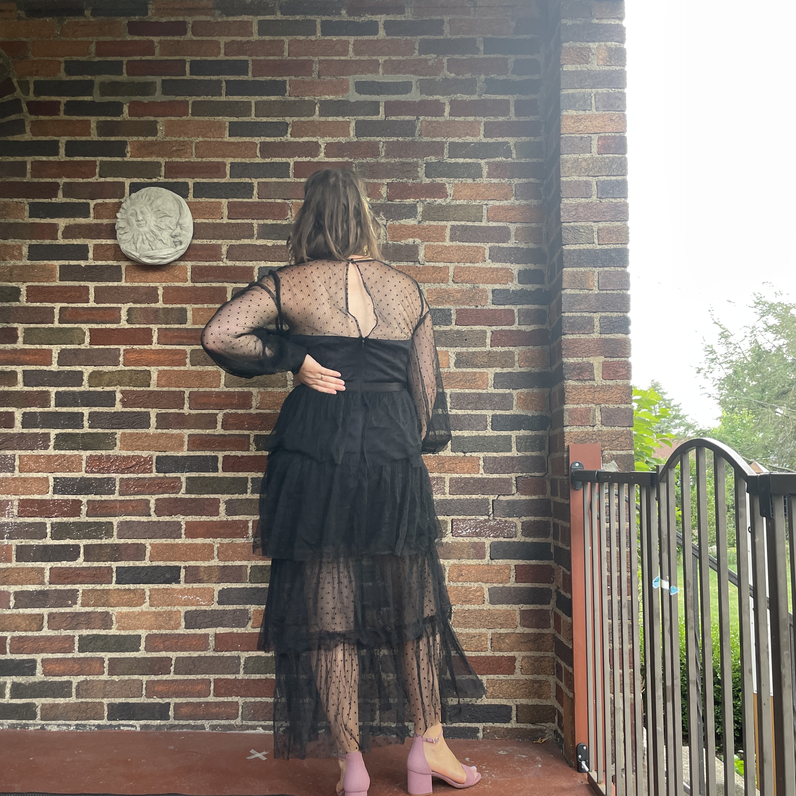 reviewer wearing black tiered nuuly dress