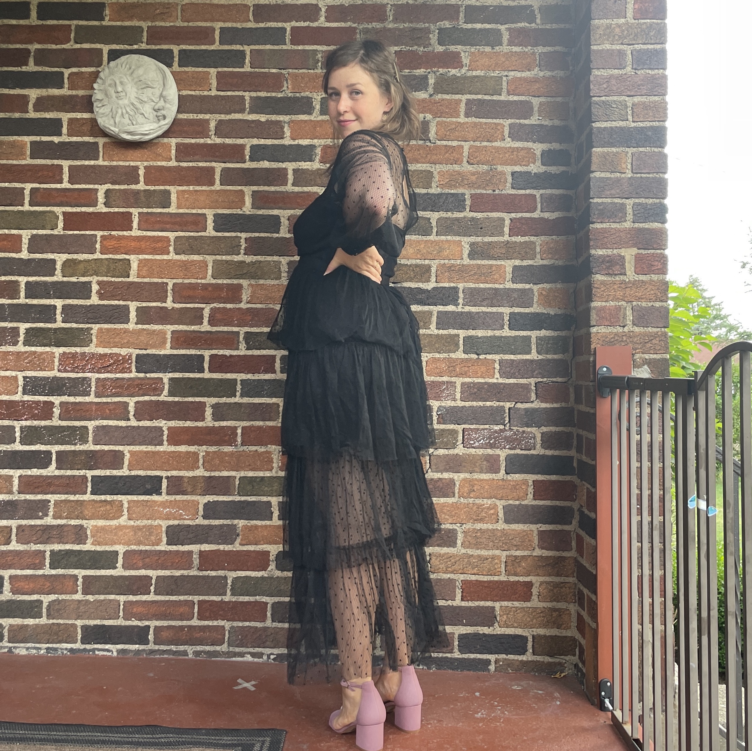 reviewer wearing black tiered nuuly dress