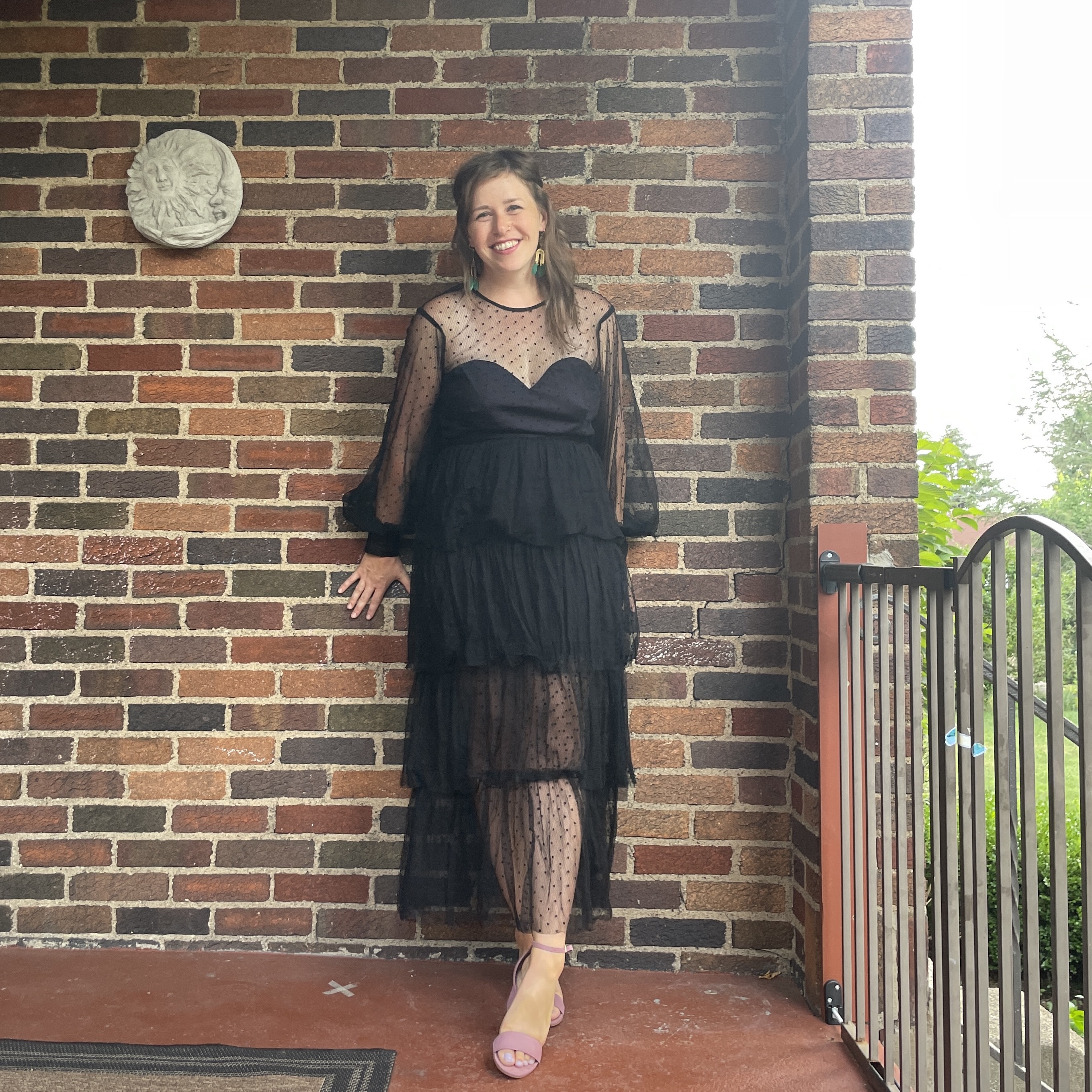 reviewer wearing black tiered nuuly dress