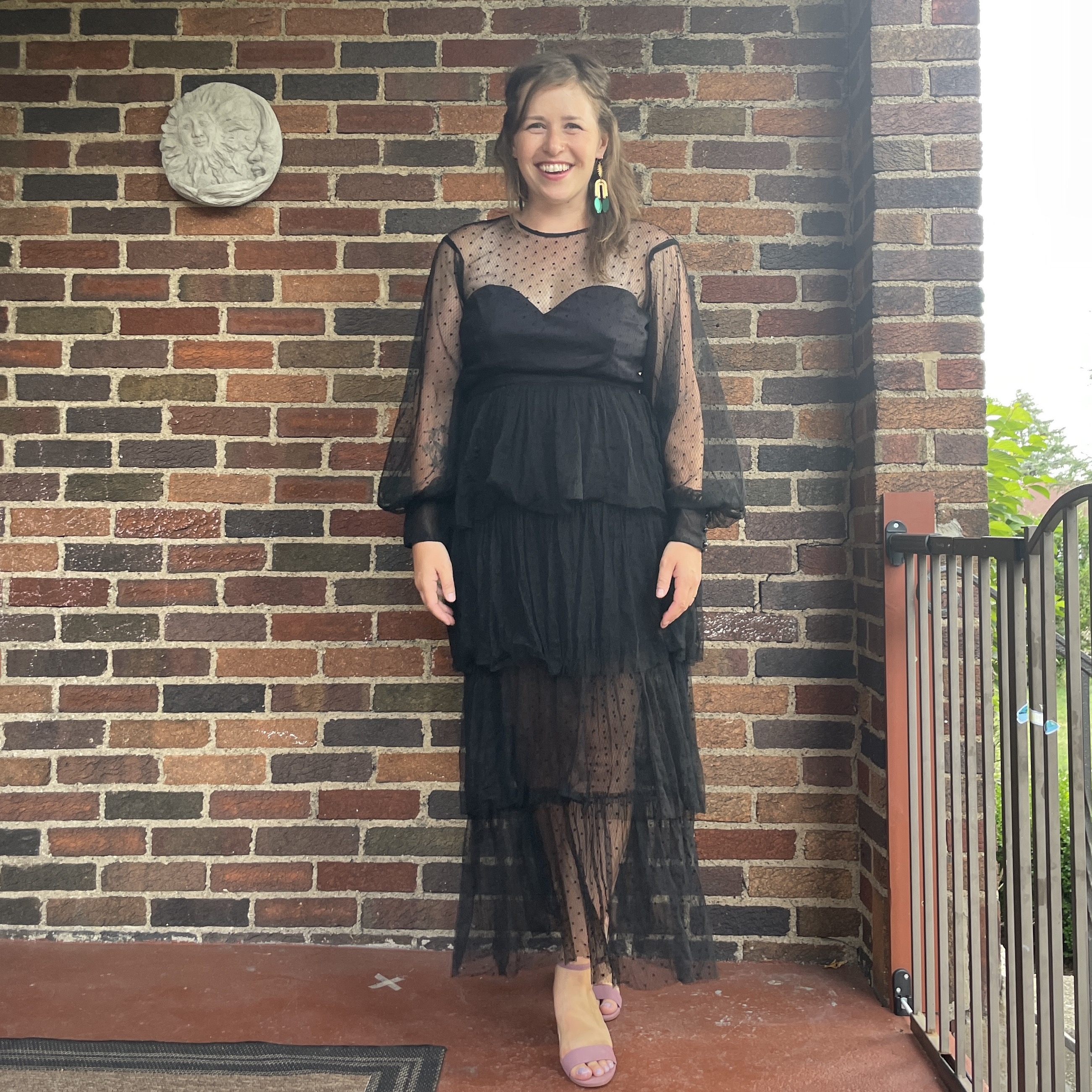 reviewer wearing black tiered nuuly dress