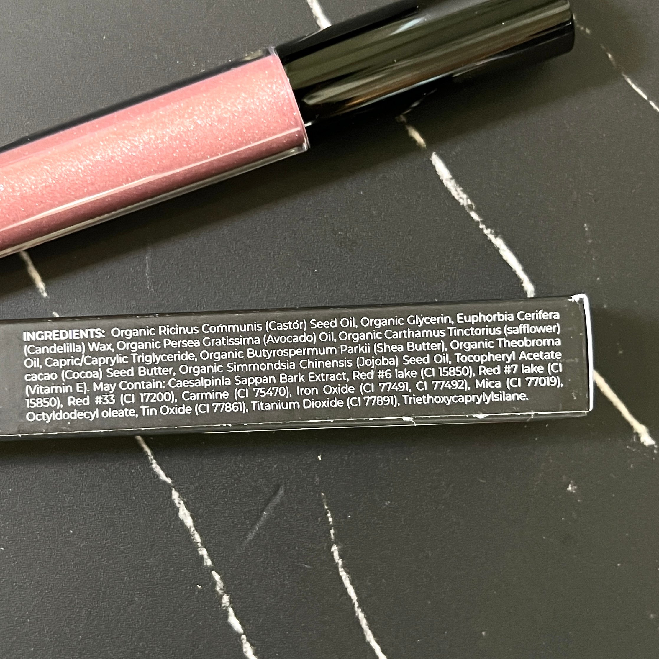 Back of Charlotte Cook Cosmetics Lip Gloss in Brooklyn for Nourish Beauty Box May 2023