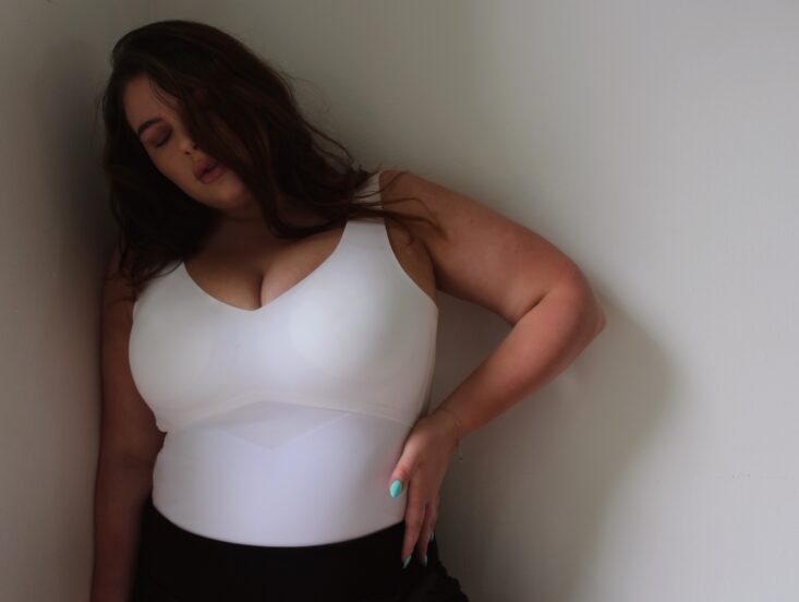 I'm in between sizes in the Honeylove Tops, what do you recommend