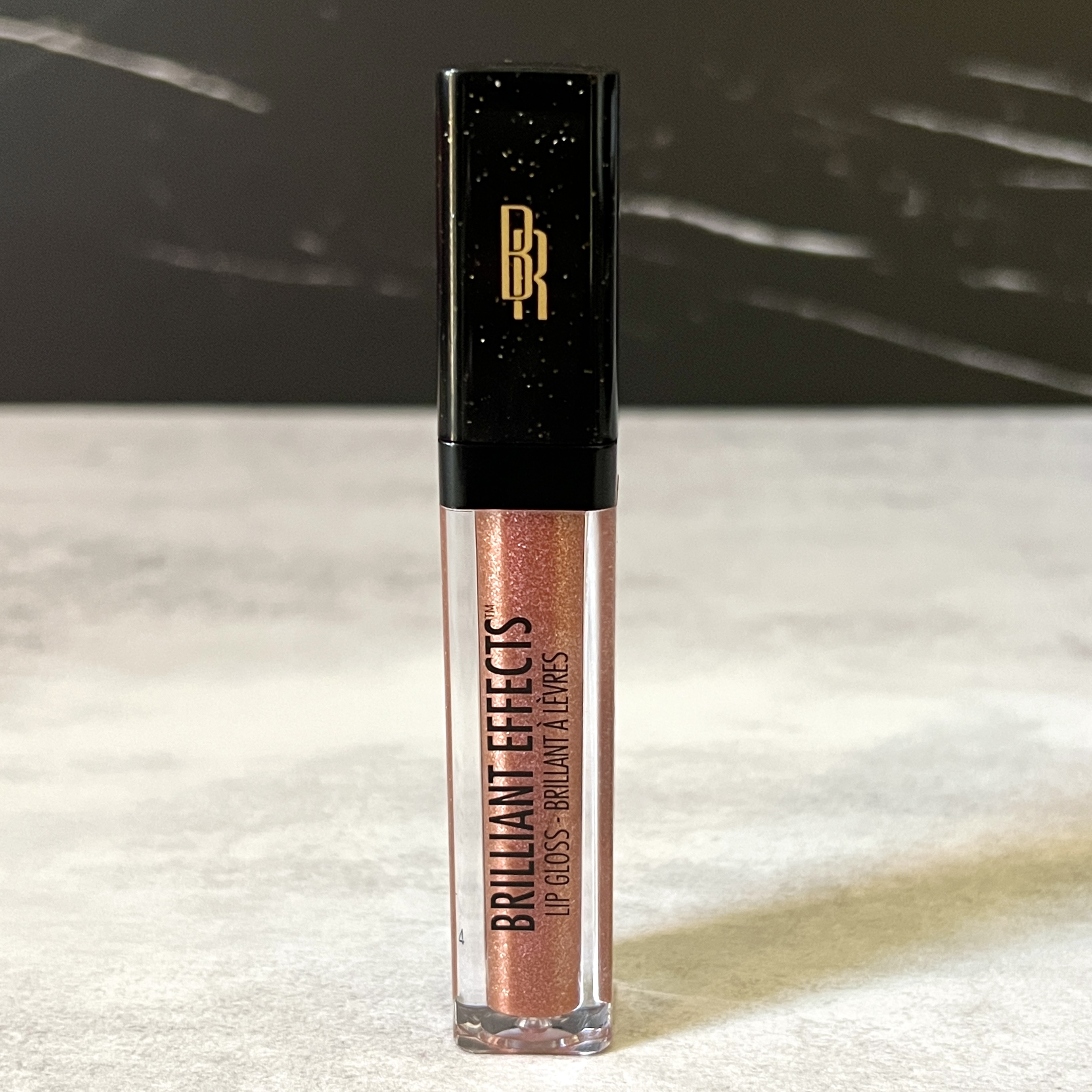 Front of Black Radiance Lip Gloss for Cocotique June 2023