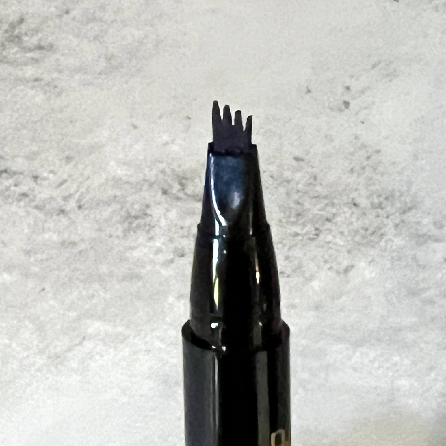 Closeup of Black Radiance Micro Brow Pen for Cocotique June 2023