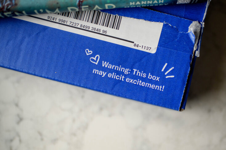 a blue Book of the Month Club box is seen on a countertop