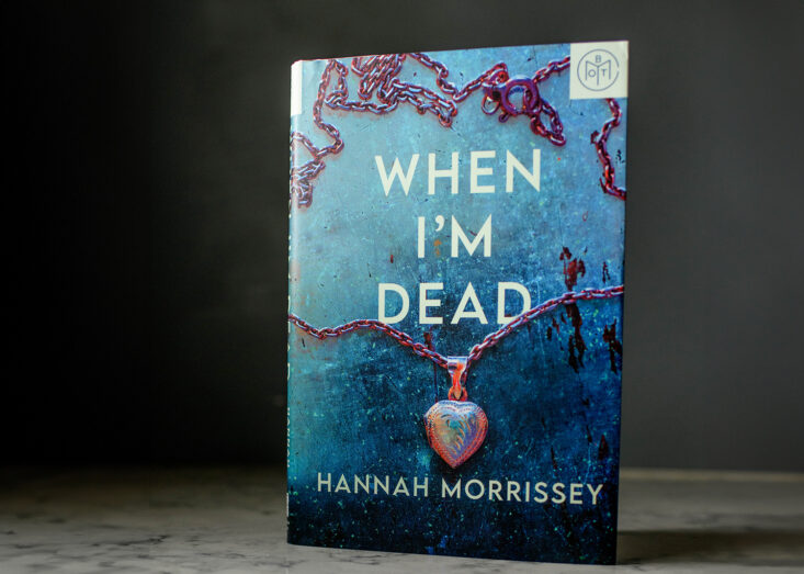 the October 2023 Book of the Month Club Book When I'm Dead stands up on a granite counter