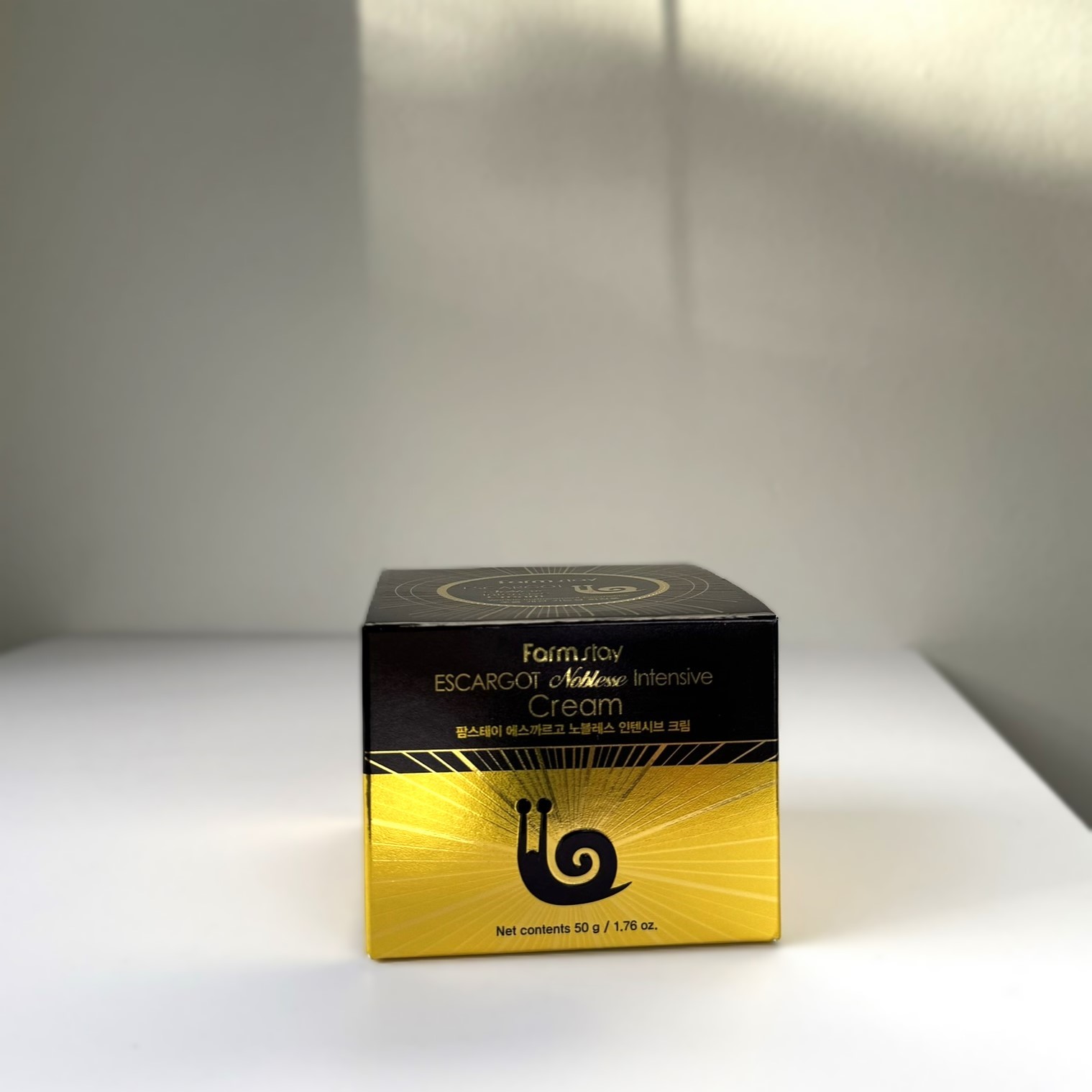 black and gold box with a snail
