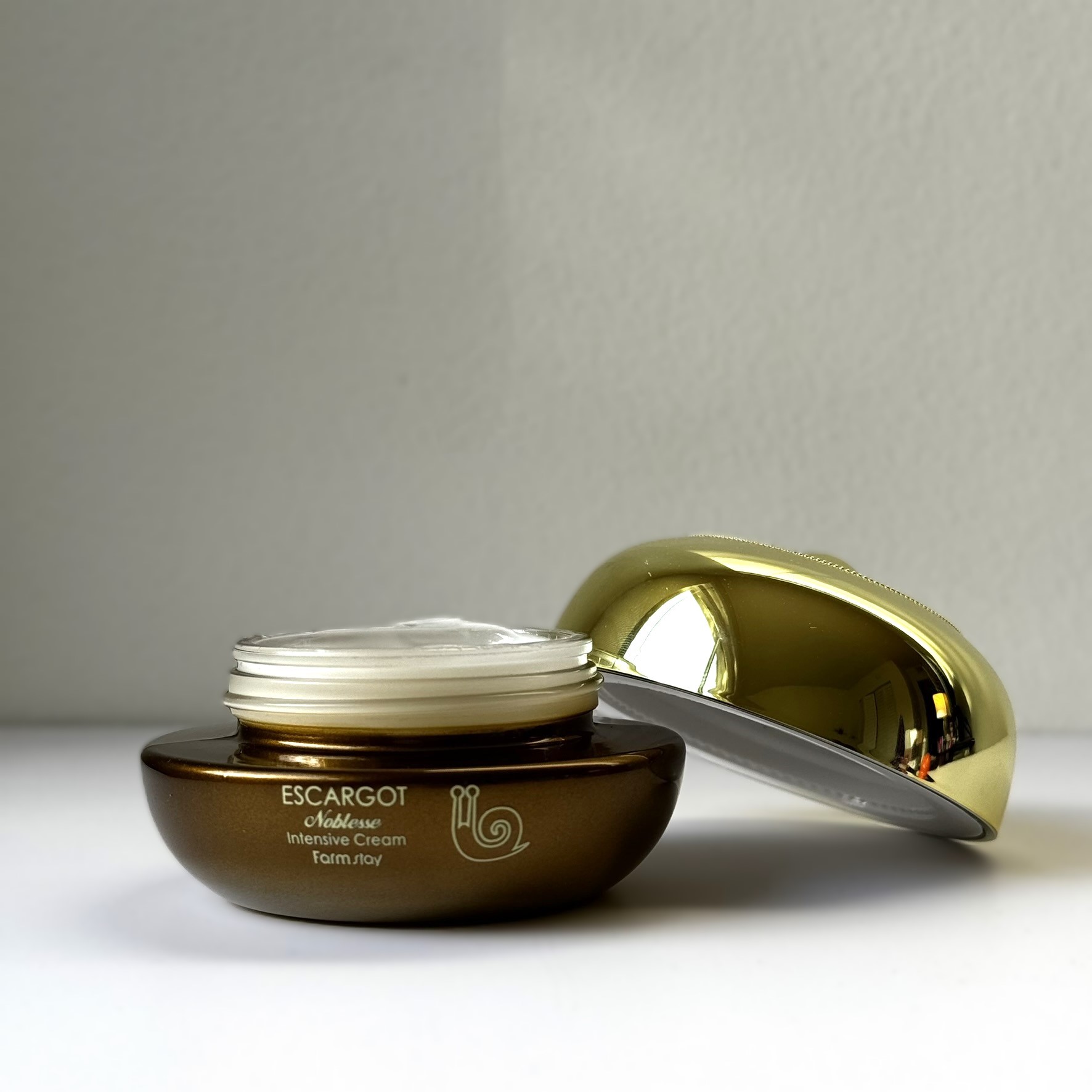 skincare jar with snail mucin and a gold cap