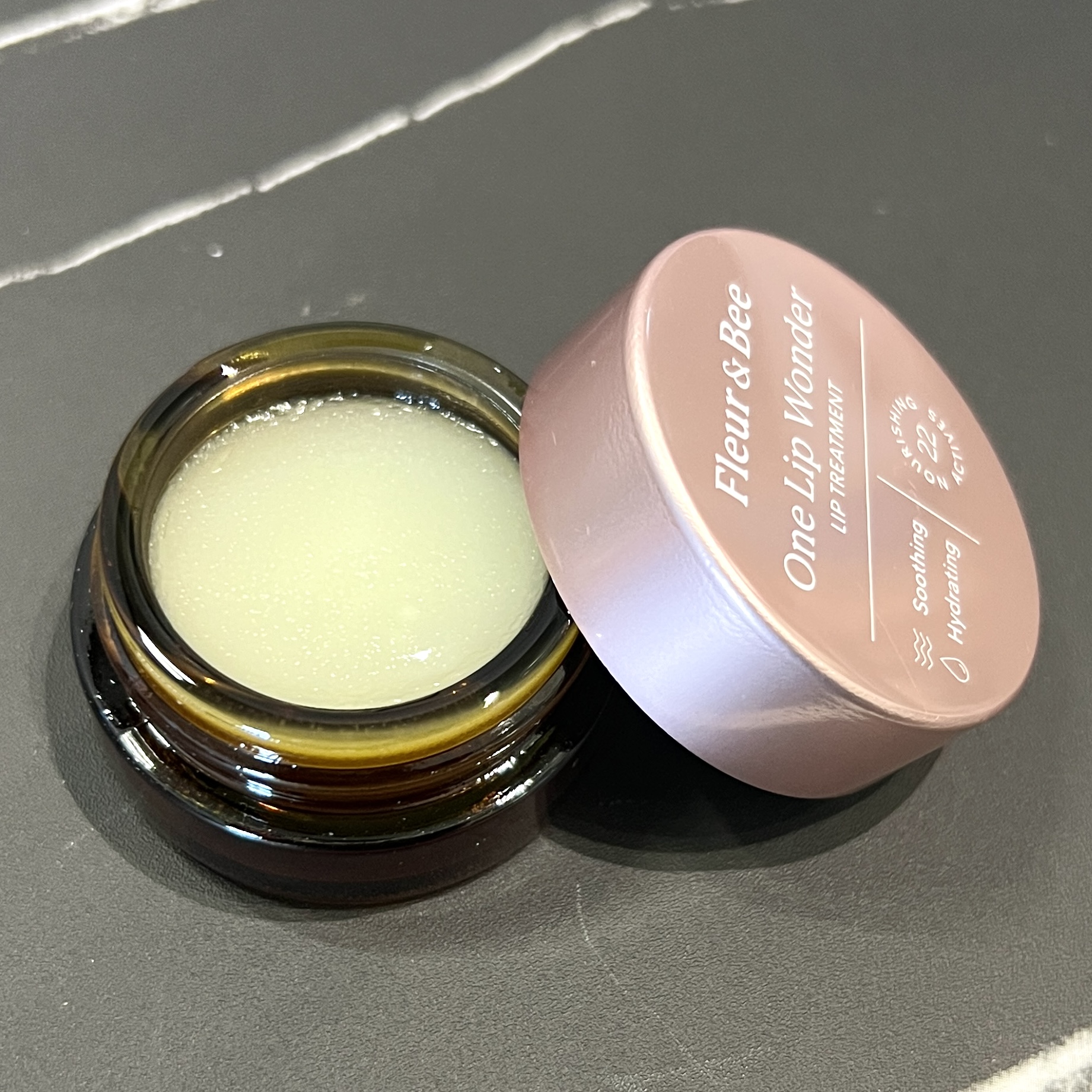 Closeup of Fleur and Bee Lip Treatment for Cocotique November 2023