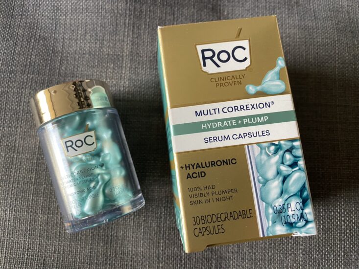 small blue skincare serum capsules inside clear bottle next to RoC Skincare MULTI CORREXION Hydrate + Plump Serum Capsules package