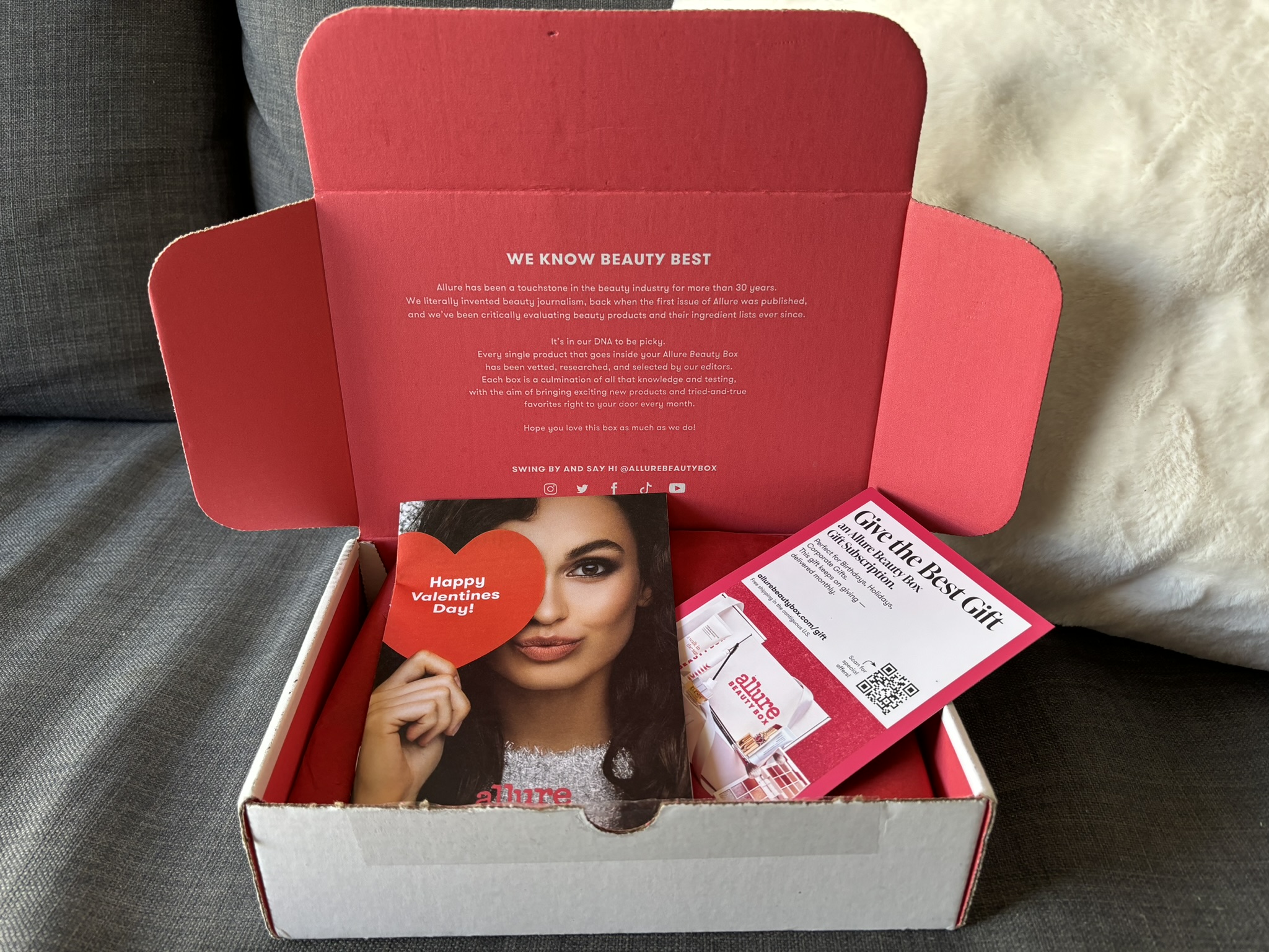 Allure Beauty Box with lipstick, skincare products, and informational pamphlet