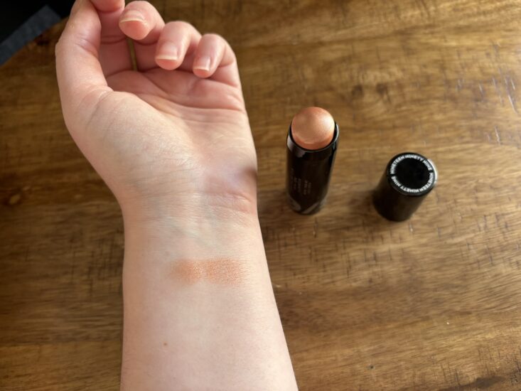 19/99 Highlight Stick swatched on arm in a coppery-color