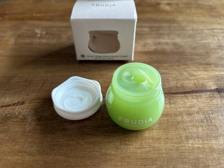 grape pore control cream container open to reveal green gel
