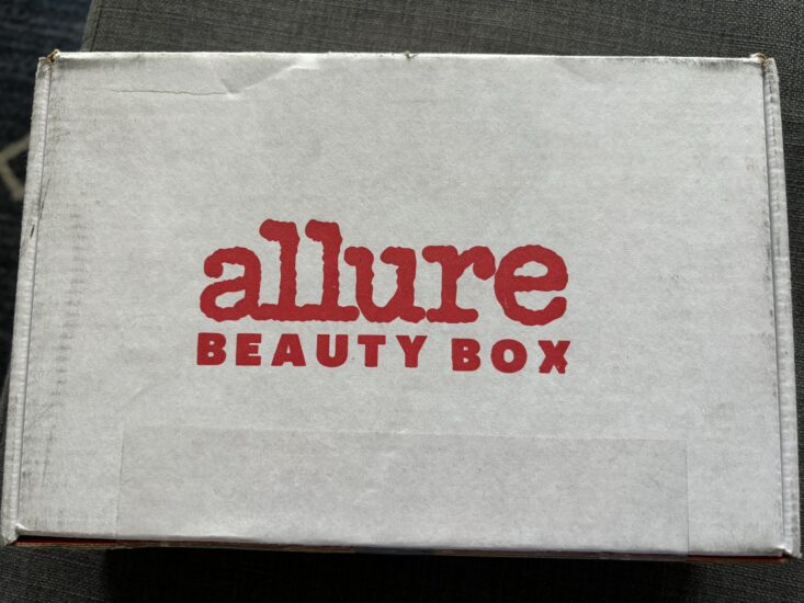 white box with red text that reads "Allure Beauty Box"