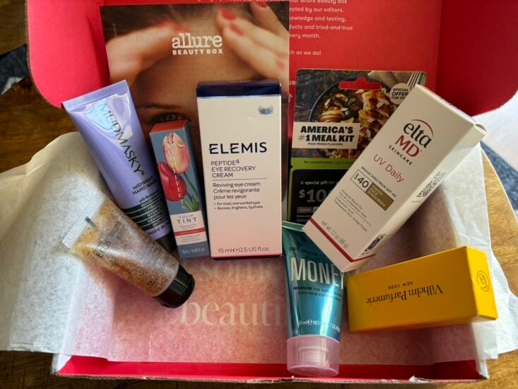 Allure Beauty Box open with different skincare, hair care, and makeup products inside