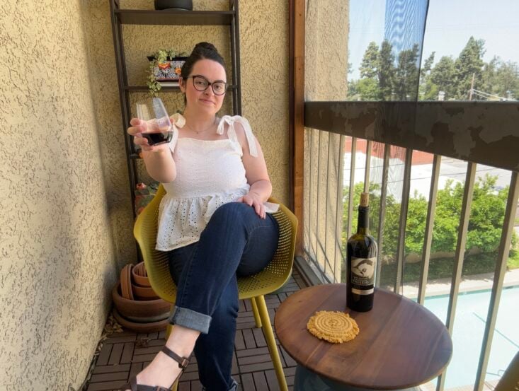 person holding glass of red wine next to bottle of Cristian Vallejo Chile Barrel Selection Cabernet Sauvignon 2019