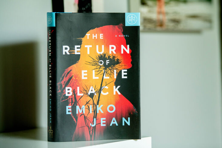 The book The return of the ellie black by Emiko Jean sits on a shelf