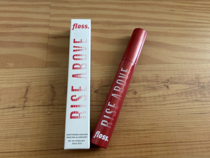 white mascara box package next to red tube of mascara