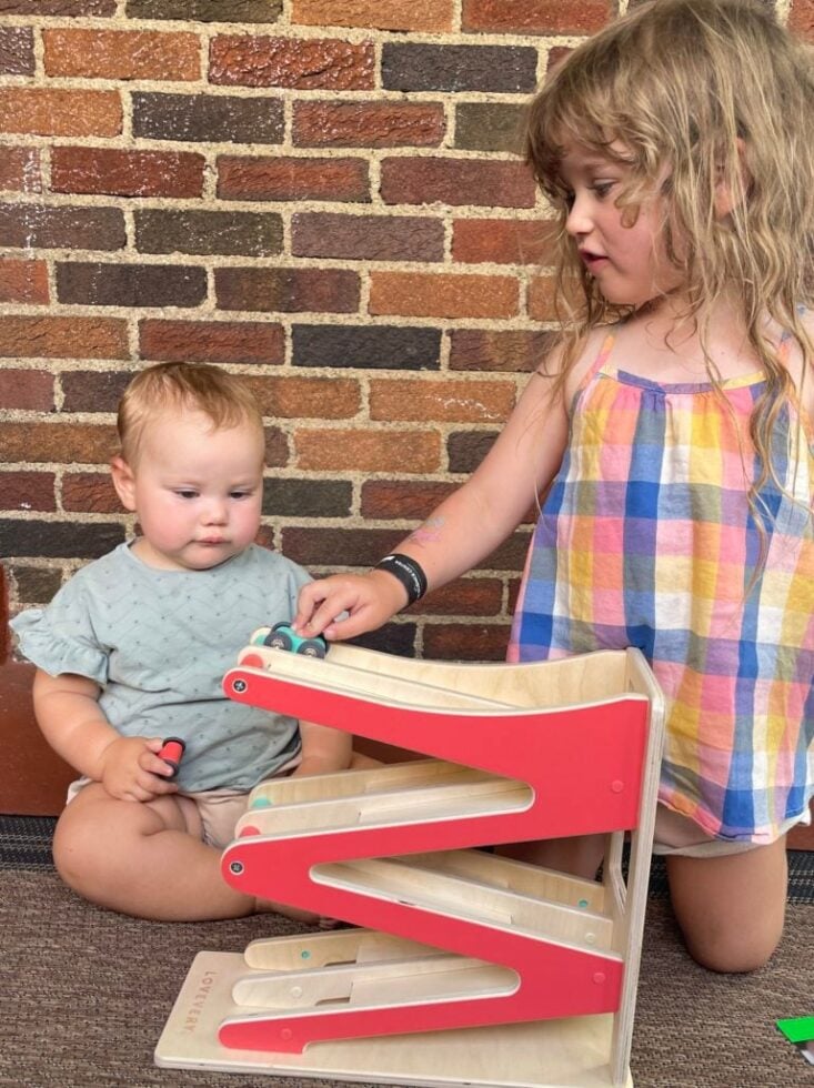 Christen's daughter and son playing with their car ramp from Lovevery.