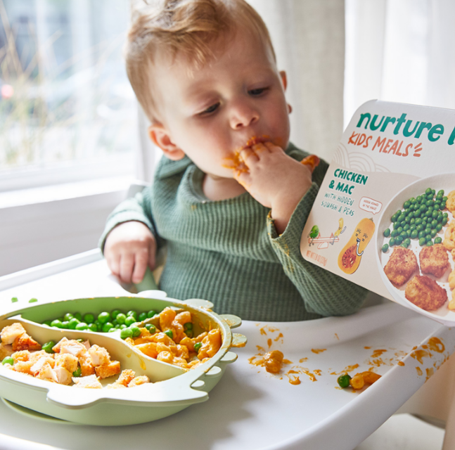 Young toddler eating Chicken & Mac from Nurture Life.