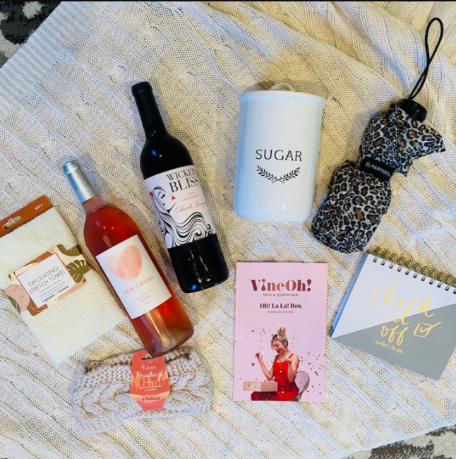 Two bottles of wine along with lifestyle items from VineOh!'s seasonal box.