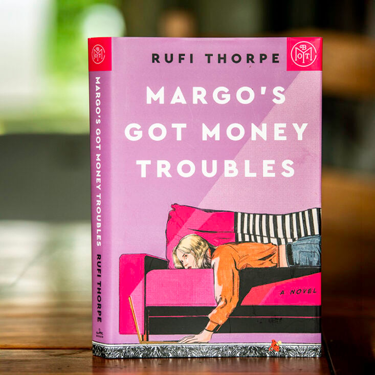 the book Margo's Got Money Troubles with a Book of the Month Club logo in the corner of the cover